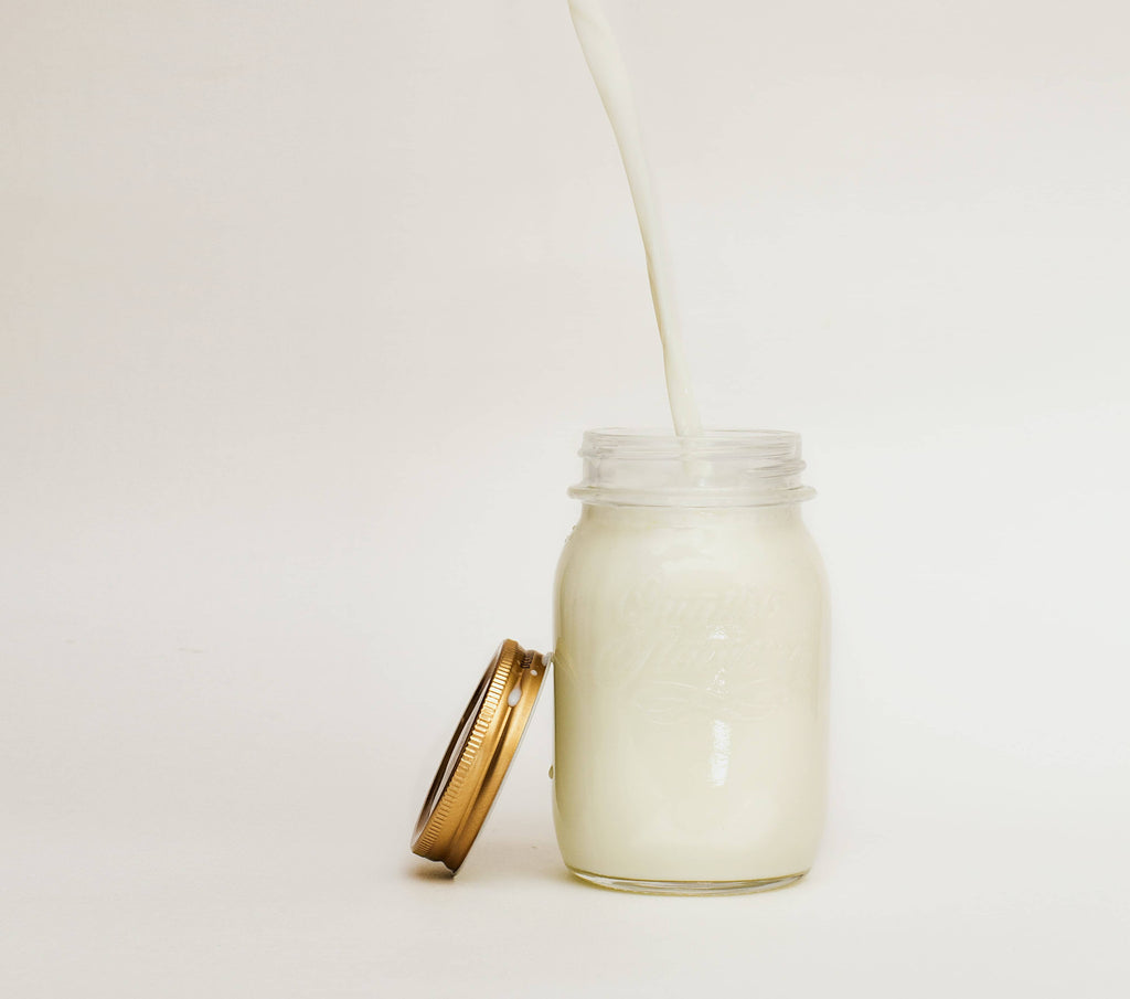 Clear jar with milk inside 